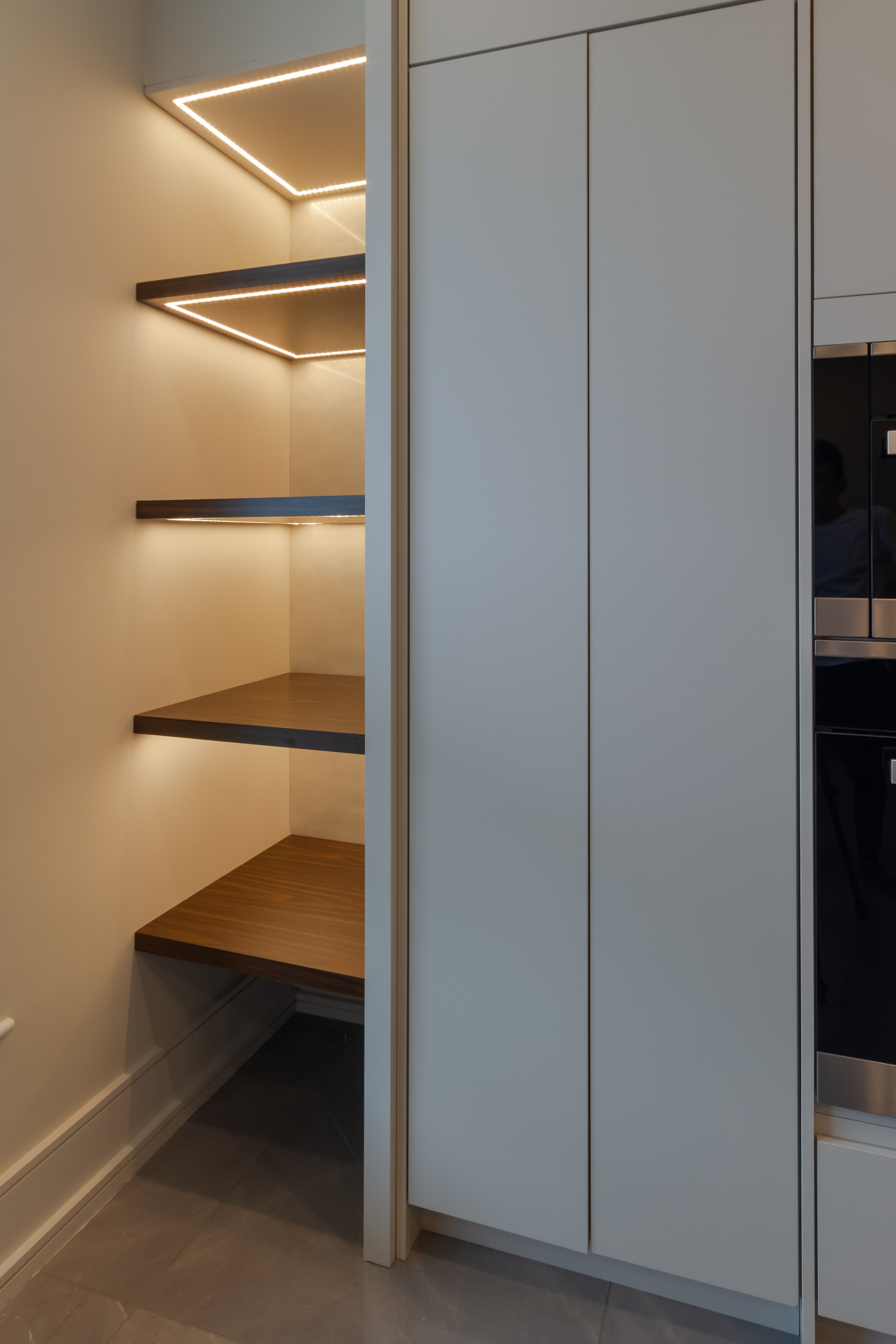 Custom fitted cabinetry with warm integrated lighting