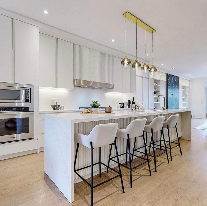 Bright Hunt Avenue kitchen with a long stone island and custom cabinetry